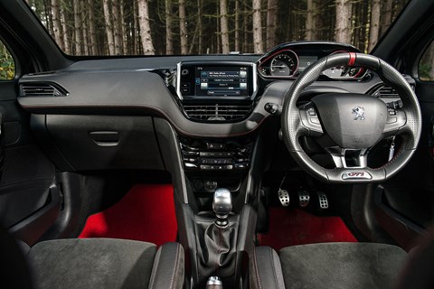 208’s tiny, bagel-esque steering wheel odd but you get used to it