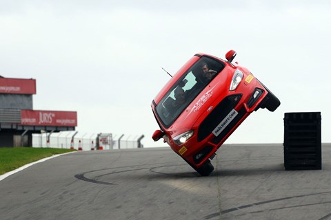 Paul Swift driving on two wheels