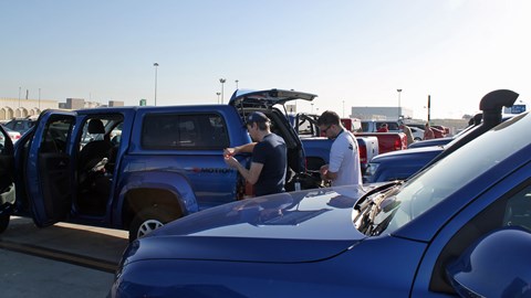 The whole range of V6 Amaroks lined up in the Muscat airport car park ahead of the trip