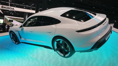 Porsche Taycan at the Frankfurt motor show 2019 - rear side view on blue plinth