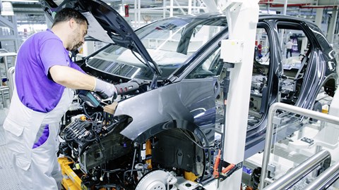 VW !D.3 being assembled in the factory - worker under bonnet