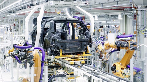 VW !D.3 being assembled in the factory - rear view, surrounded by robots