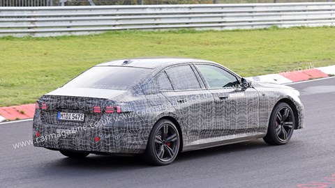 New 2023 BMW i5 spy shots: rear three quarter cornering image, camouflaged car, track testing