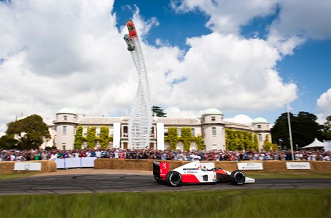 Jenson Button drives McLaren MP4-6 past Goodwood House