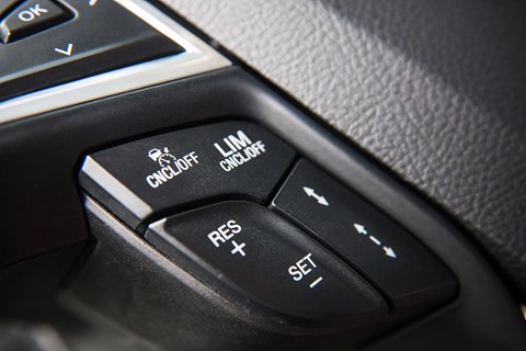 Activated through steering wheel-mounted buttons , the engine management system limits the supply of fuel