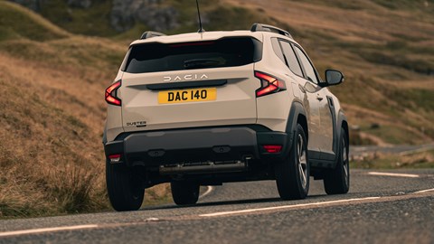 Dacia Duster review - rear, driving round corner