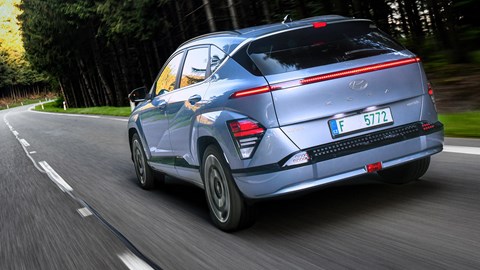 Hyundai Kona Electric review - rear, driving through forest