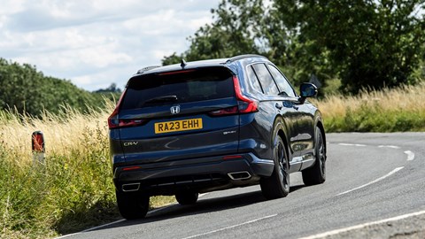 Honda CR-V Hybrid review - rear, blue, driving round corner
