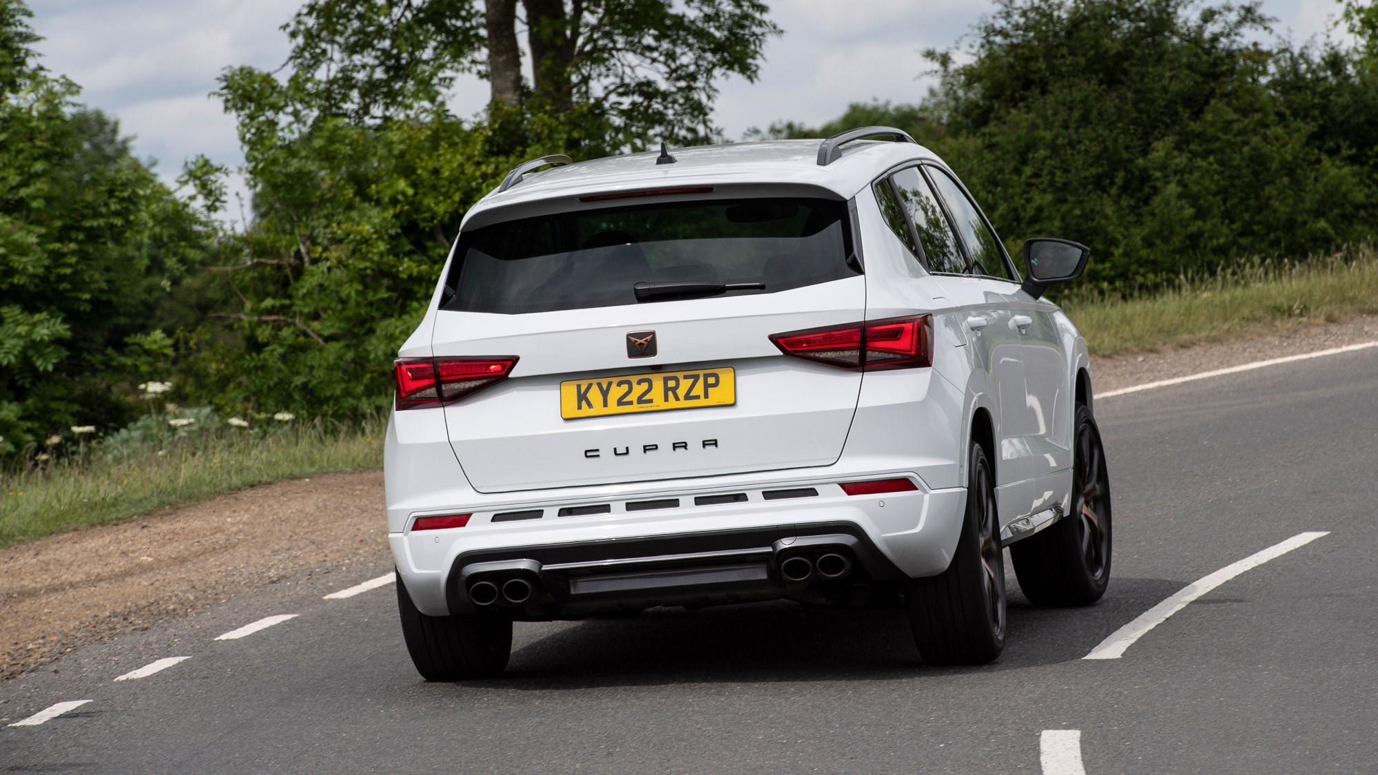Cupra Ateca review - facelift, rear view, white, driving round corner