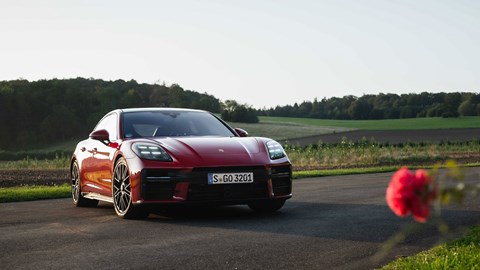 Porsche Panamera GTS: front three quarter static, red paint, sunset
