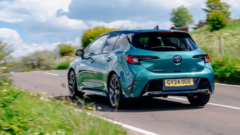 Toyota Corolla review - rear, teal, driving uphill