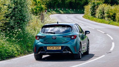 Toyota Corolla review - rear, teal, driving round corner