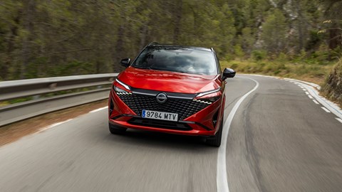 Nissan Qashqai e-Power (2025) review: front three quarter cornering, red paint, low angle