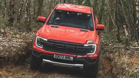Ford Ranger Raptor (2023) review: driving through a muddy gully, orange paint
