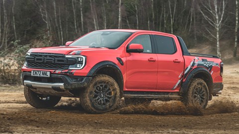 Ford Ranger Raptor (2023) review: side view cornering shot on dirt, orange paint