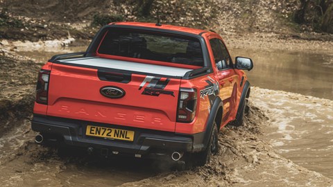 Ford Ranger Raptor (2023) review: fording through water, rear view, orange paint