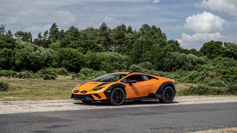 Image of a Lamborghini Huracan Sterrato, in orange, from the left side, static