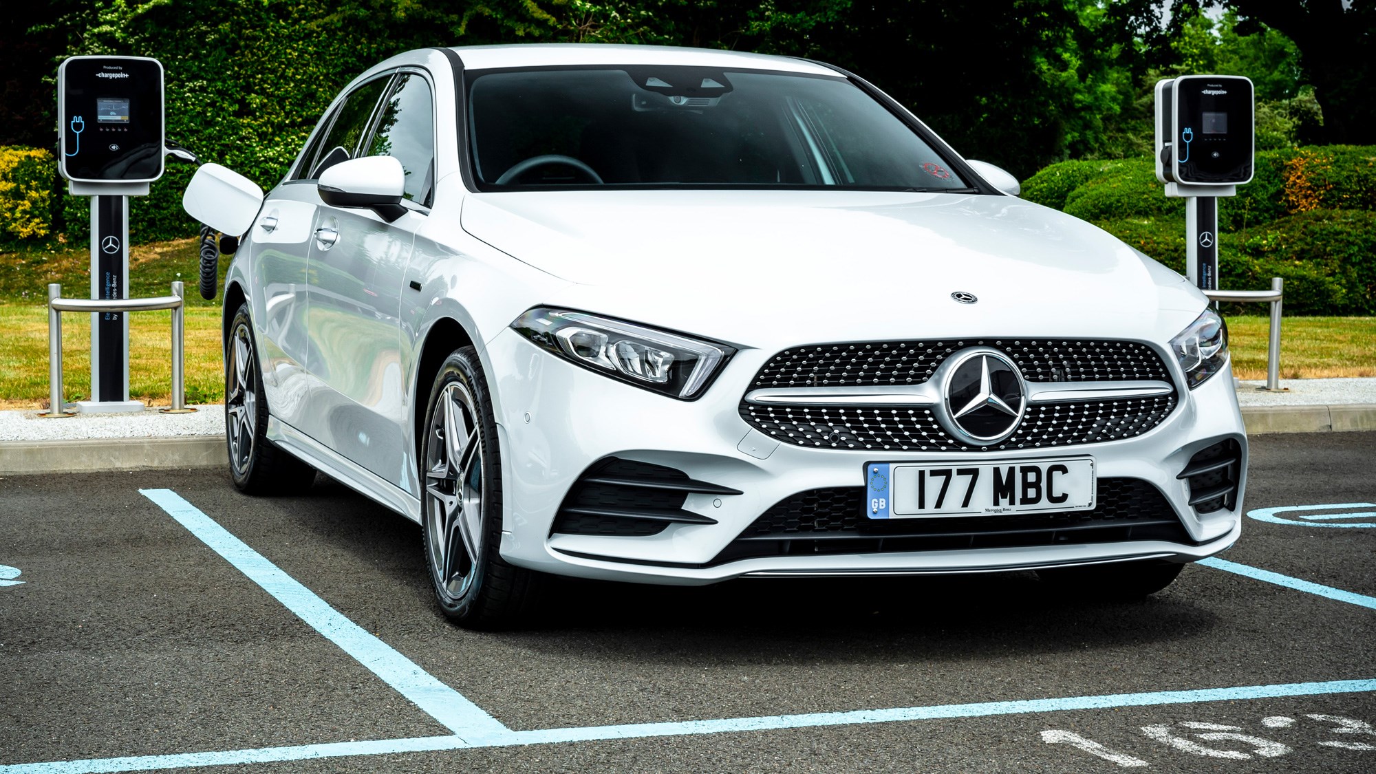 Mercedes-Benz A250e plug-in hybrid review, 2020, white, side view, charging
