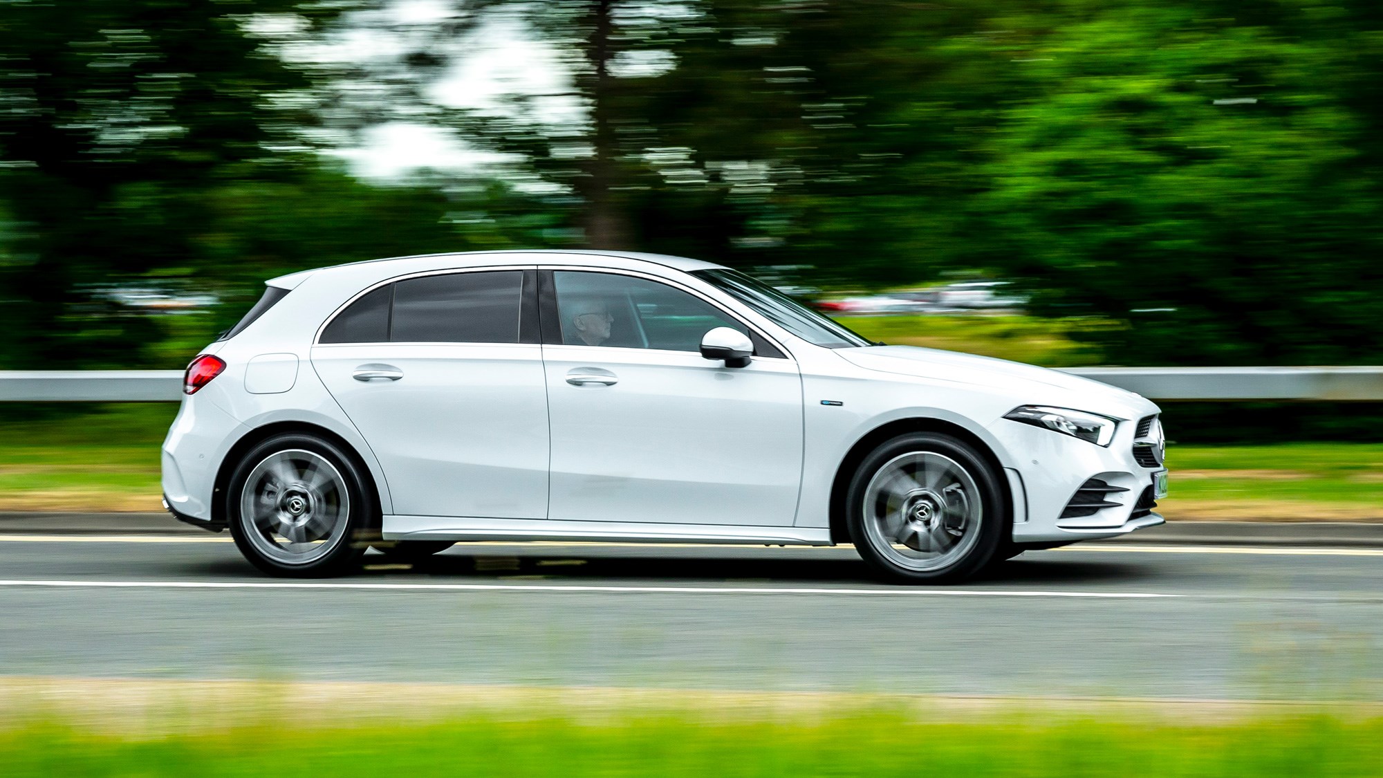 Mercedes-Benz A250e plug-in hybrid review, 2020, white, side view, driving