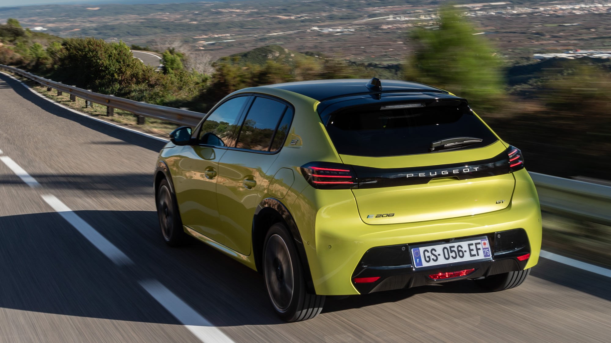 Peugeot E-208 review - rear, driving, yellow