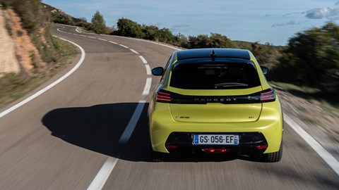 Peugeot E-208 review - dead-on rear, driving, yellow