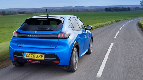 Peugeot e-208 electric car review - rear view, driving, blue