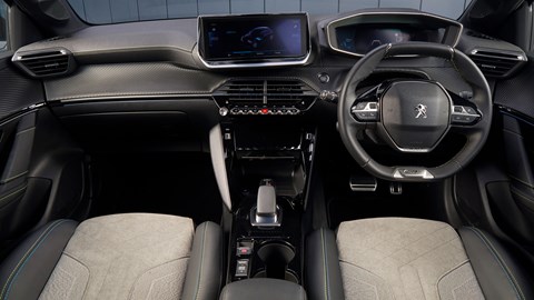 Peugeot e-208 electric car review - interior, showing i-Cockpit dashboard design with high-mounted instruments and small steering wheel