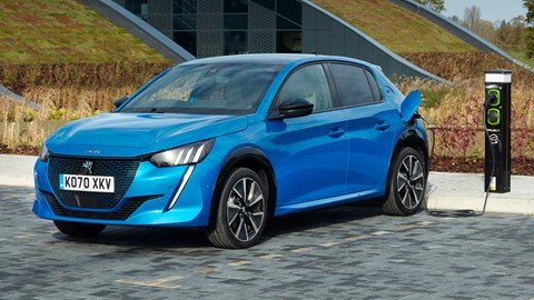 Peugeot e-208 review - front view, blue, plugged into electric car charger