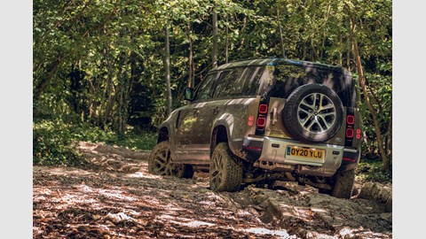 Land Rover Defender (2020) off-road view from rear, driving