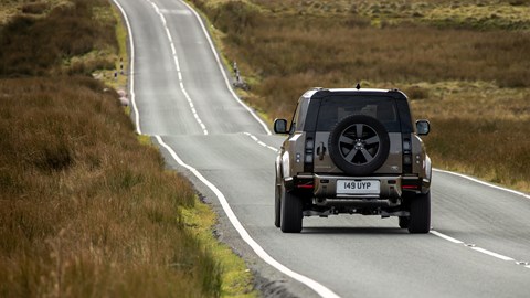 Gold 2021 Land Rover Defender 90 X P400 driving rear elevation