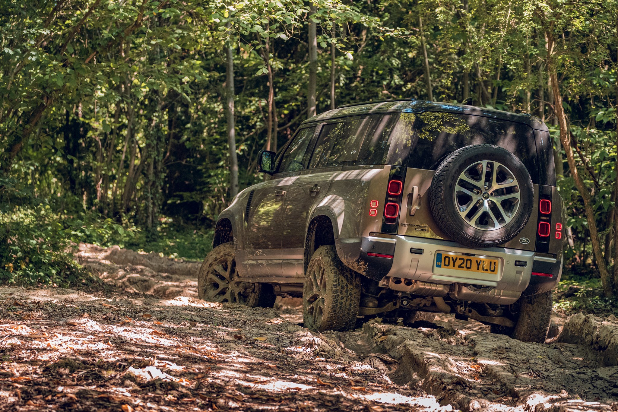 Land Rover Defender (2020) off-road view from rear, driving