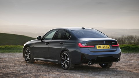 BMW 330e (2024) review: rear three quarter static, grey paint