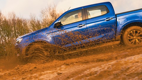 Isuzu D-Max driving down a muddy hill