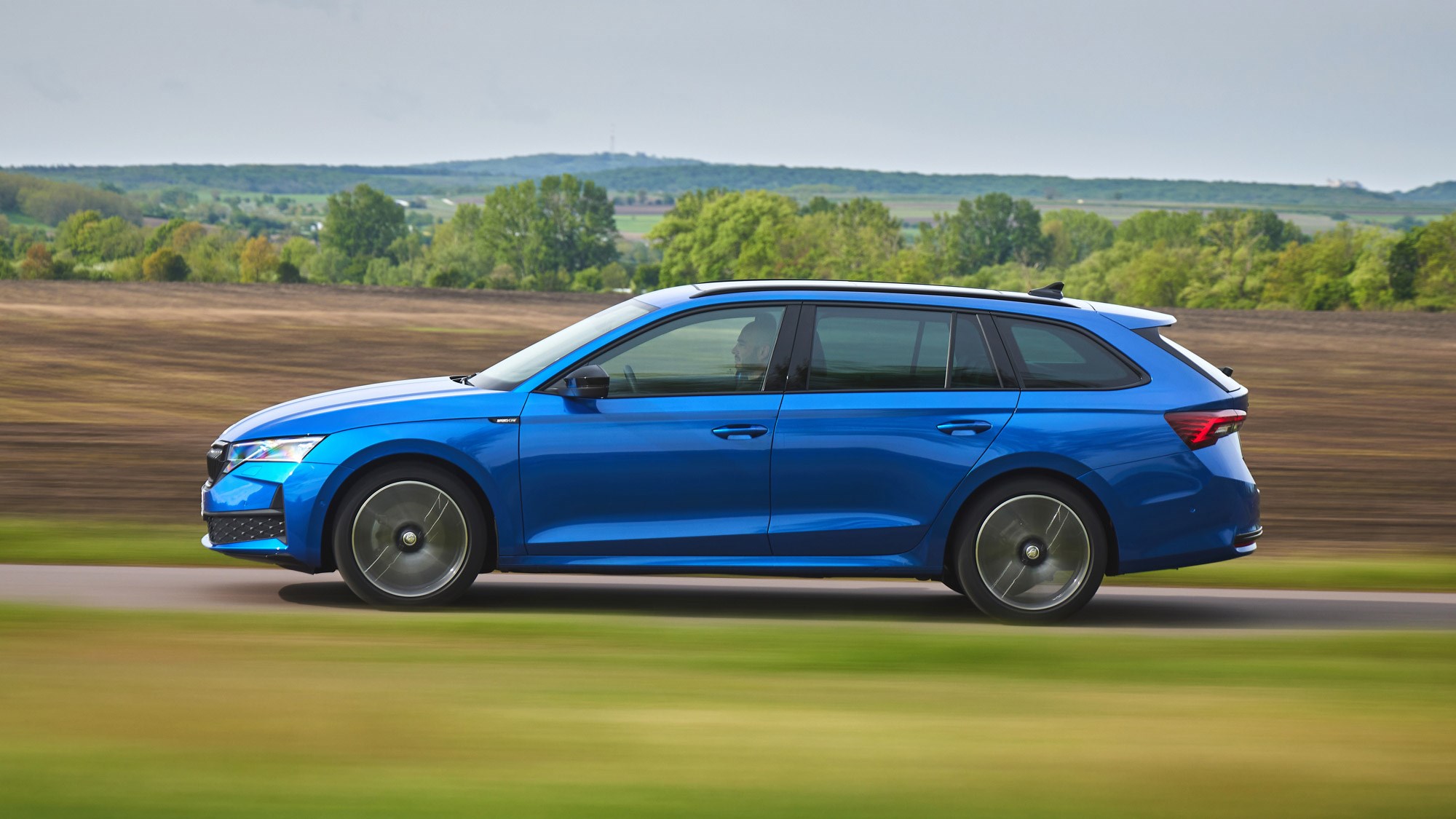 Skoda Octavia Estate review - facelift, side, blue, Sportline, driving