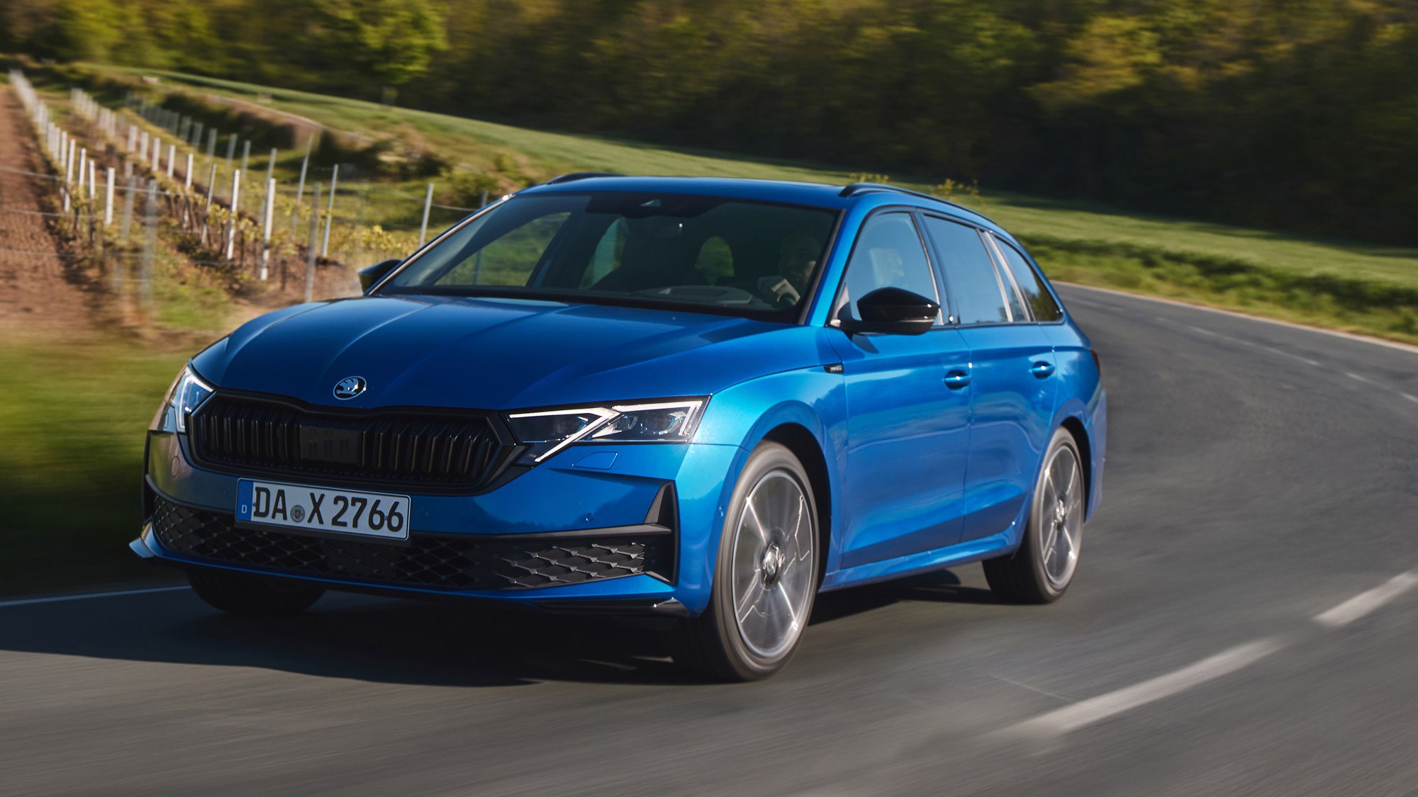 Skoda Octavia Estate review - facelift, front, blue, Sportline, driving round corner