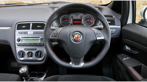 Fiat Grande Punto Abarth interior is a comfy place to sit – with only a few gripes. We don't like that speckled dash trim, for example