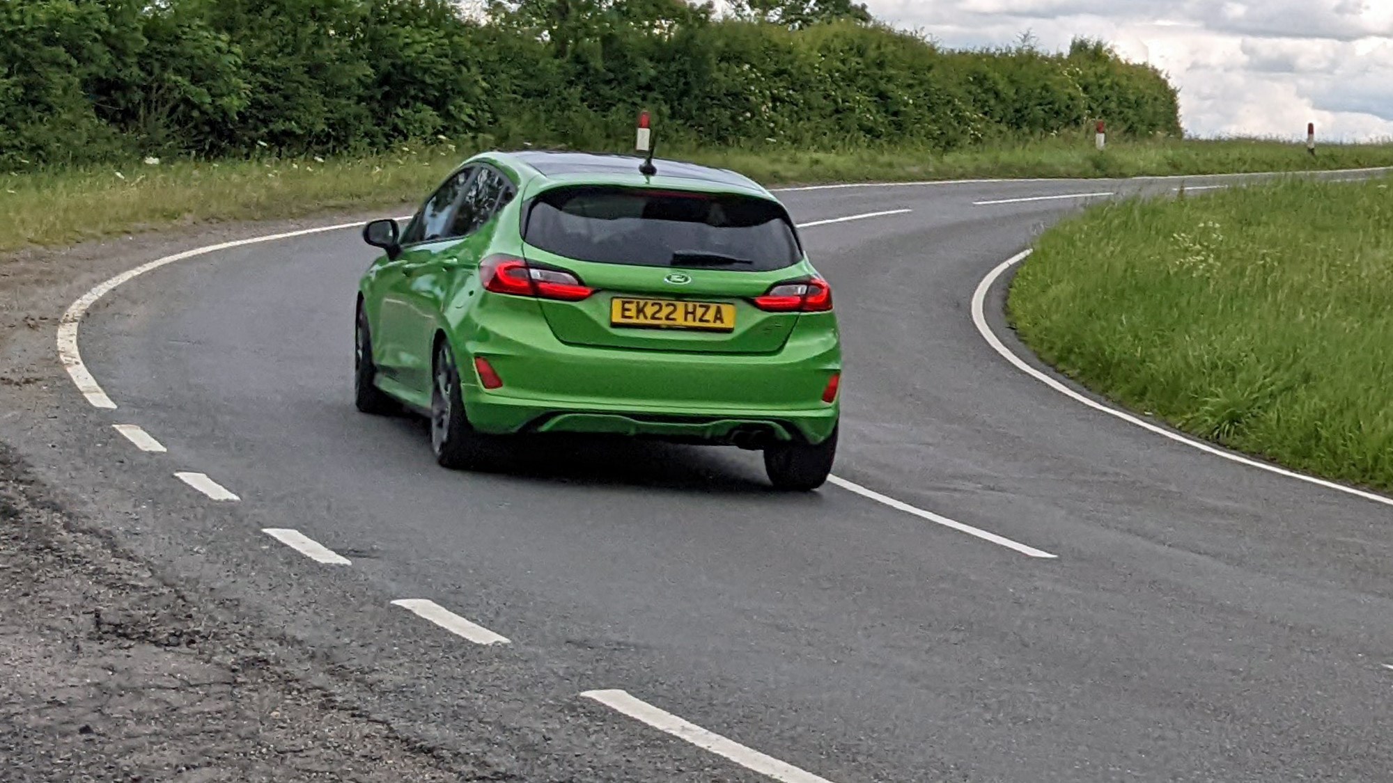 Ford Fiesta ST 2022 facelift five-door, rear view, Mean Green, ST-3, driving round corner