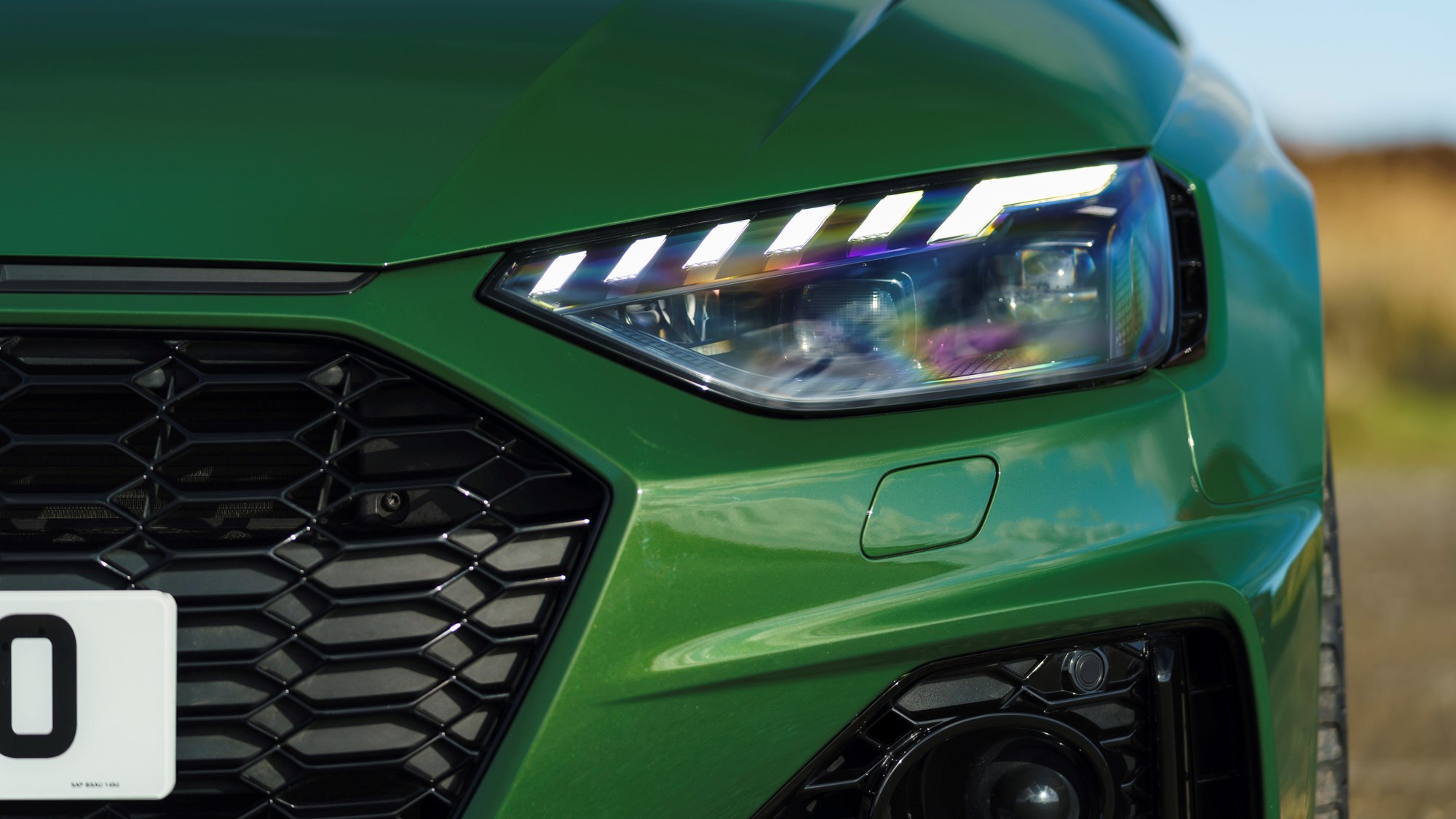 Green 2021 Audi RS4 Avant headlamp and grille detail