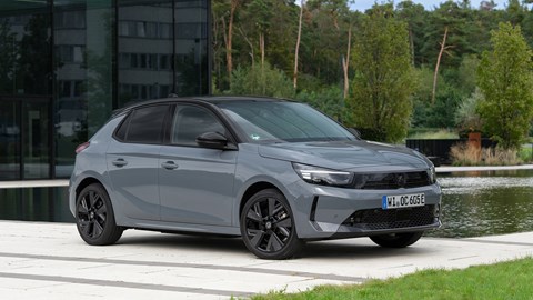 Vauxhall Corsa Electric (2023) review: front three quarter static, modern building in background, grey paint