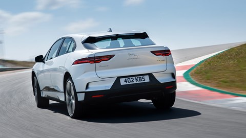 Jaguar i-Pace review - silver, rear, driving round corner on circuit