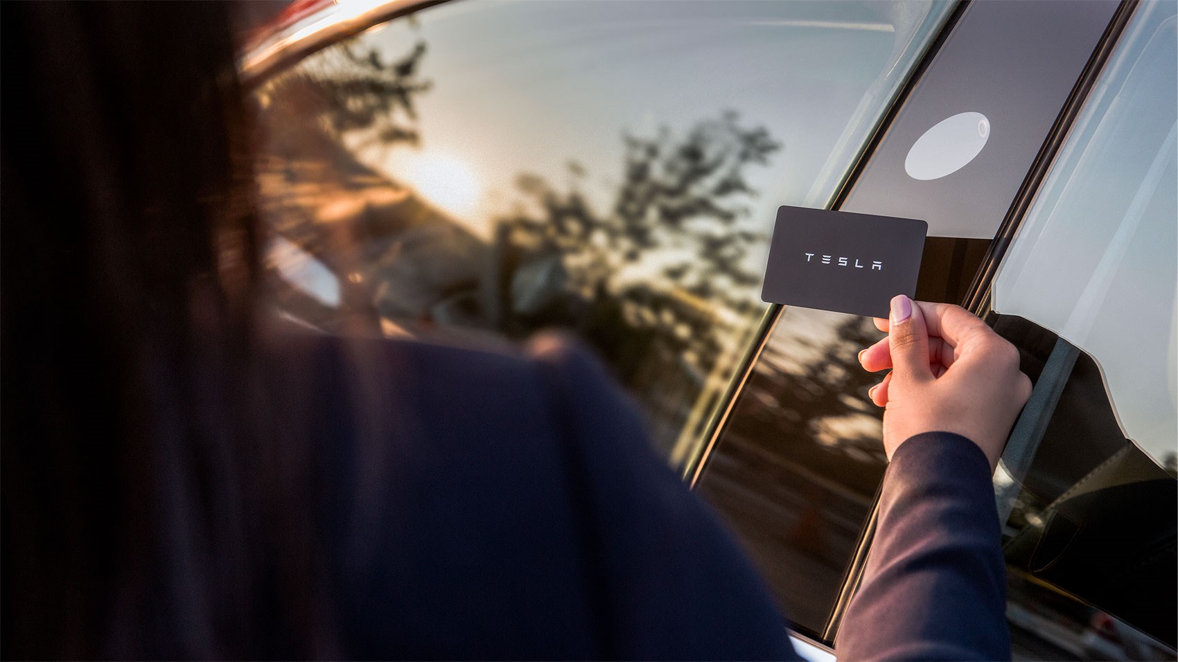 Hold up a Tesla credit card size access key to the B-pillar to unlock the Model 3