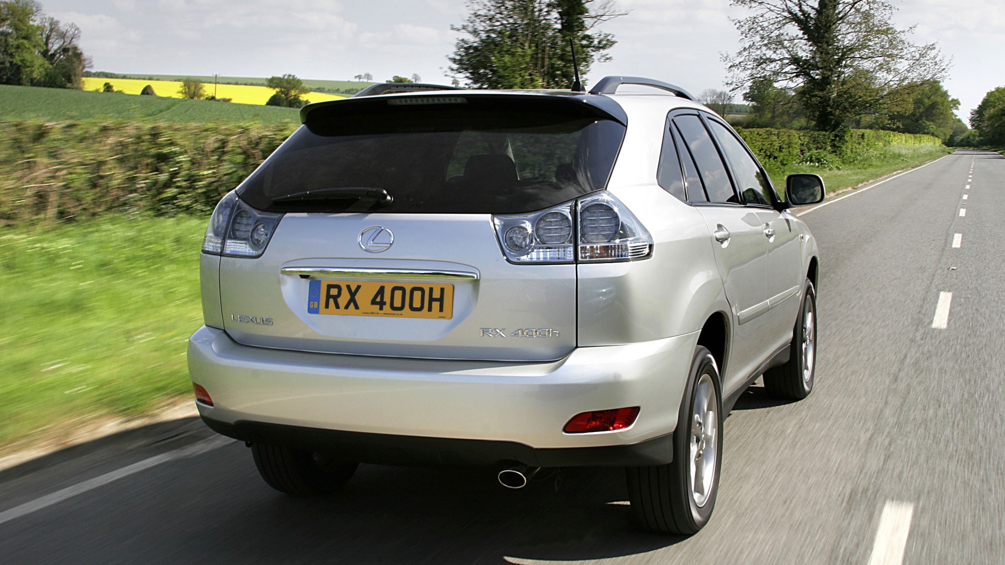 Lexus RX400h hybrid SUV review - rear view, silver, driving