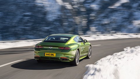 Bentley Continental GT Speed plug-in hybrid - rear, green, driving round mountain corner