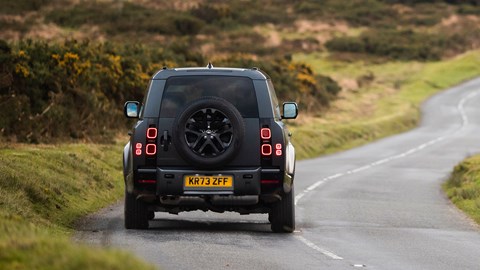 Land Rover Defender V8: rear driving, cornering, black car
