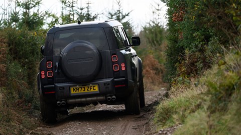 Land Rover Defender V8: rear three quarter off-roading, black car