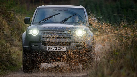Land Rover Defender V8: front three quarter off-roading, water splash, black car