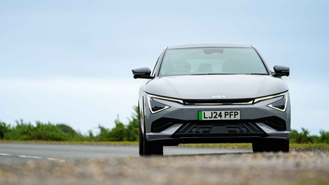 Kia EV6 facelift review: front three quarter cornering, low angle, grey paint
