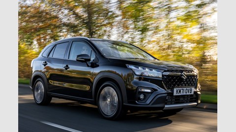 Suzuki S-Cross (2022) review: front three quarter driving shot, wooded back road, blue car