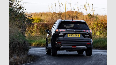 Suzuki S-Cross (2022) review: rear cornering shot, blue car, leafy B-road