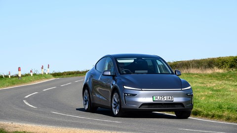 Tesla Model Y (2025) review: front three quarter driving, long lens, silver paint
